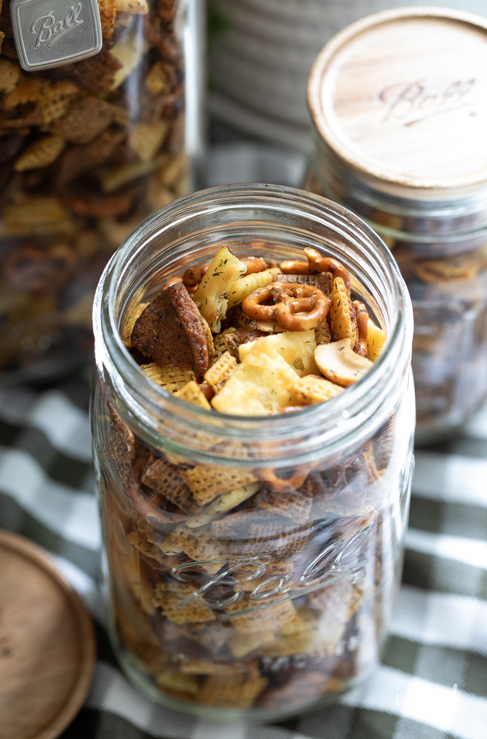 dill pickle snack mix in a mason jar with the lid off. 