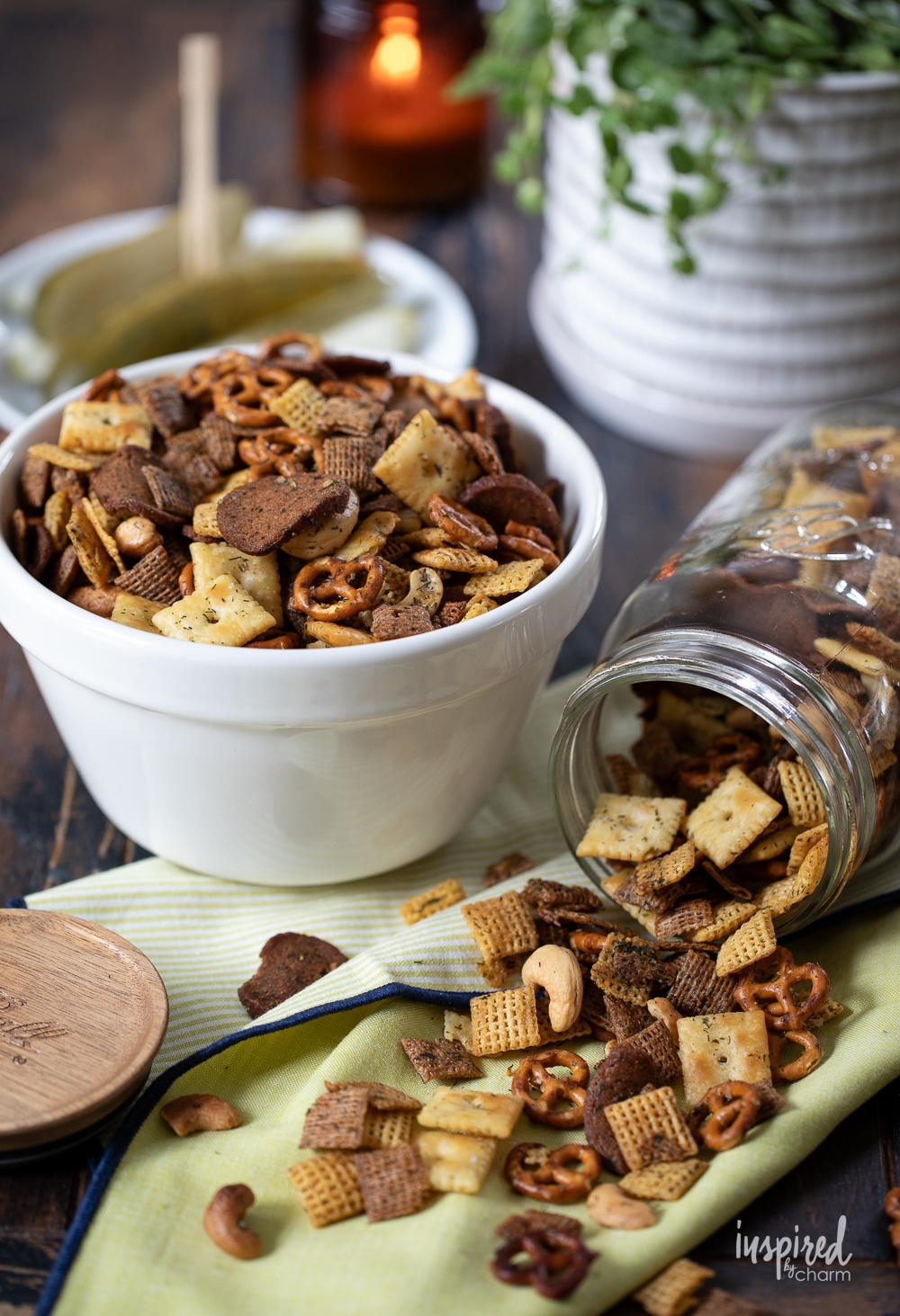 dill pickle snack mix in a bowl with more spilling out of a jar.