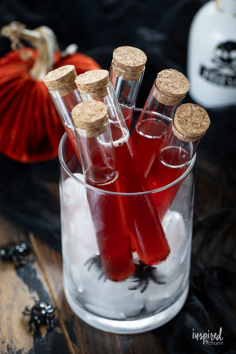 vampires kiss halloween shot recipe served in vials with corks. 