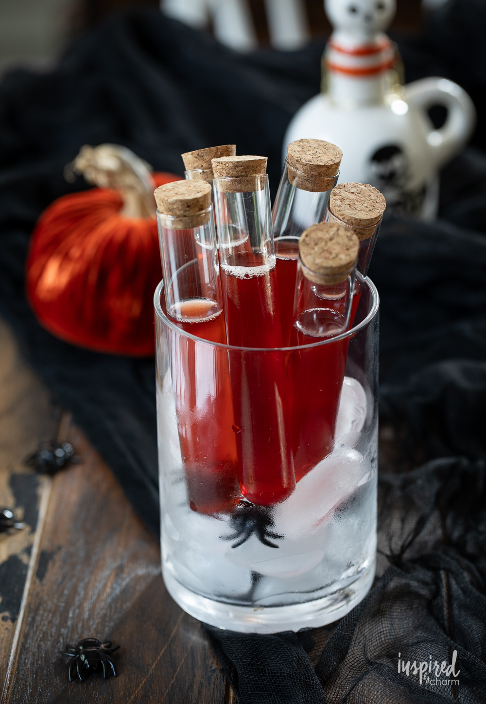 halloween shots served in a vial and in a glass vase with ice.
