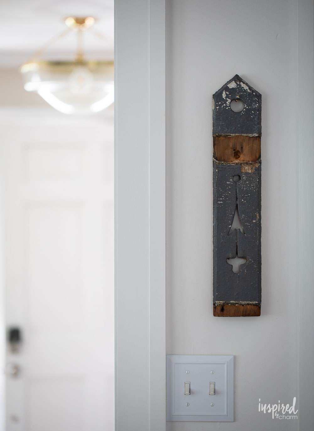 small architectural salvage piece hung on a wall. 