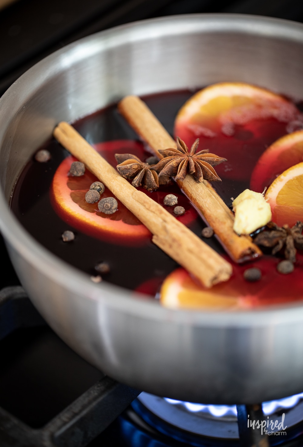 spiced cranberry hot toddy mix in a sauce pan.