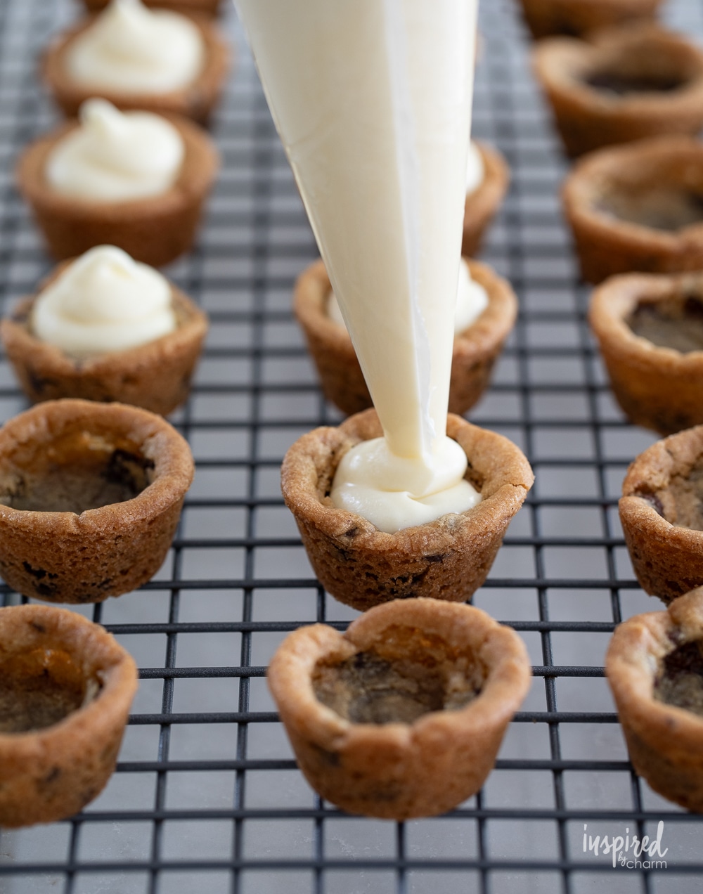 filling cookie cups with cheesecake filling.