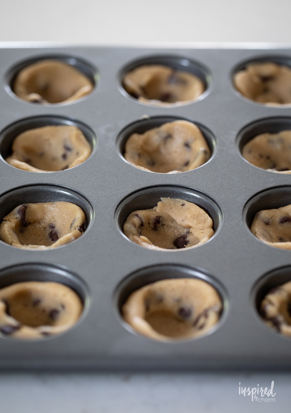 chocolate chip cookie dough pressed into mini muffins pans.
