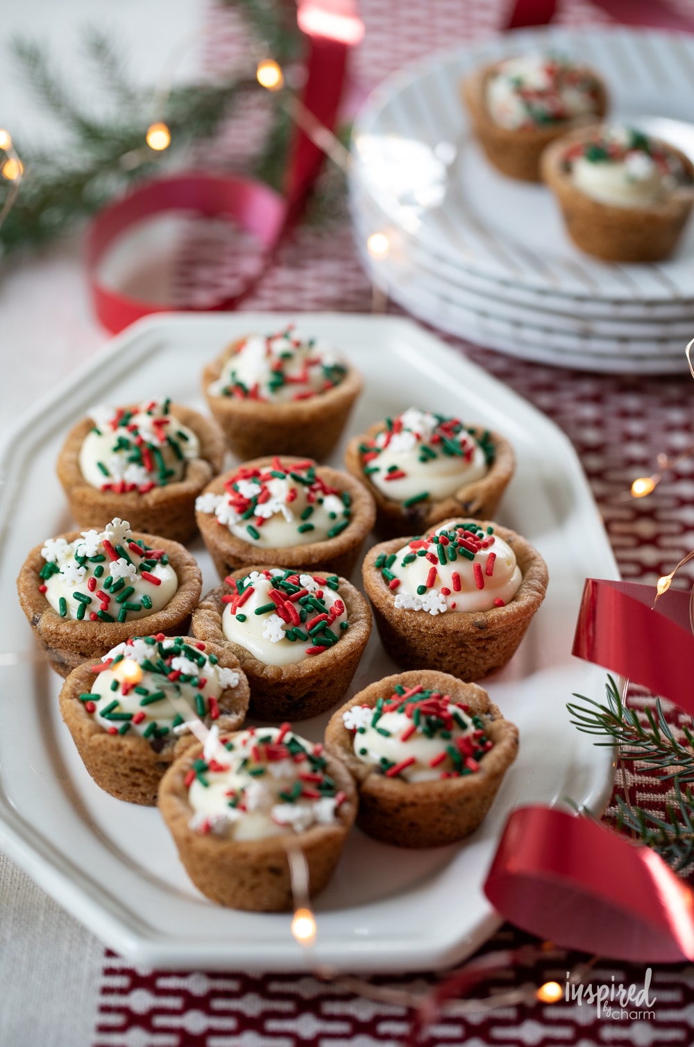 cheesecake cookie cups decorated with Christmas sprinkles.