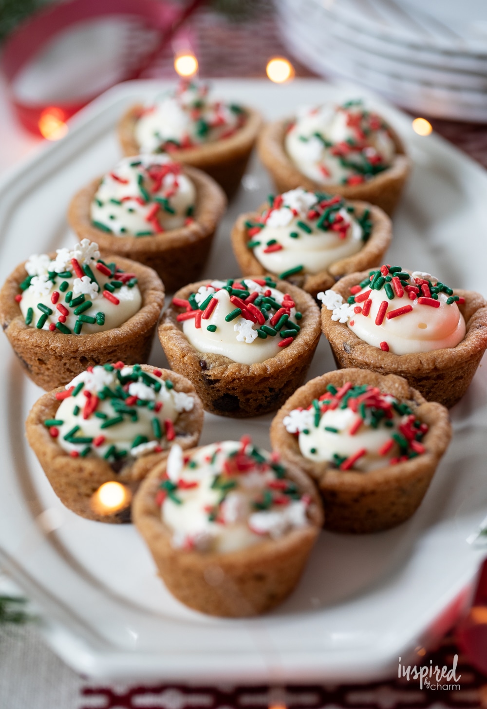 cookie cups filled with cheesecake and topped with sprinkles.