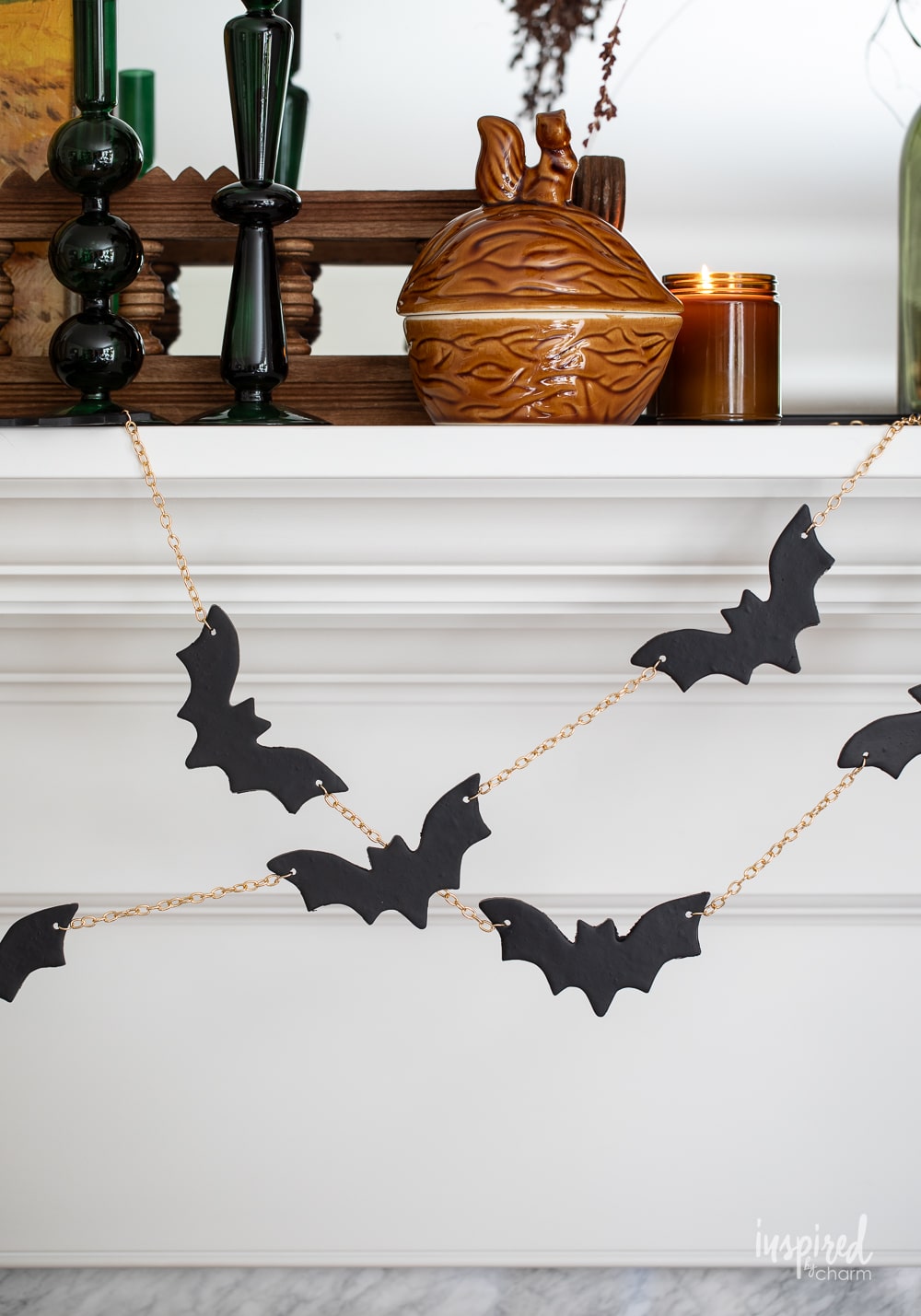 black bat garland hung on a mantel.