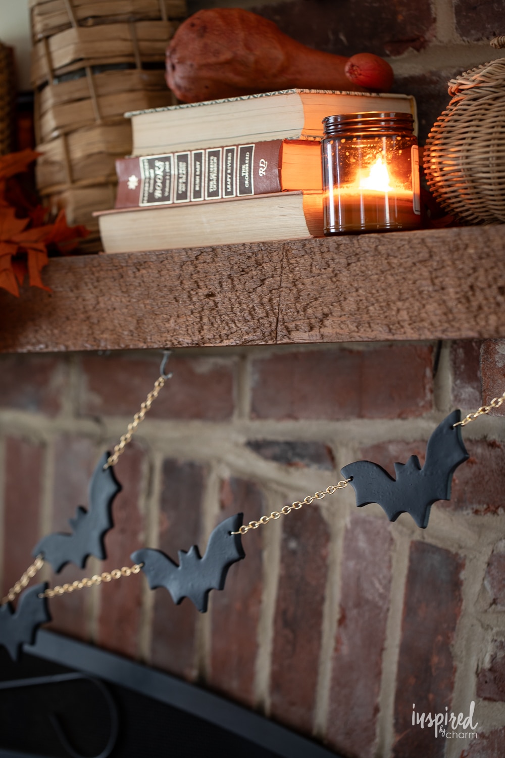 black bat and gold chain halloween garland hung on a mantel. 