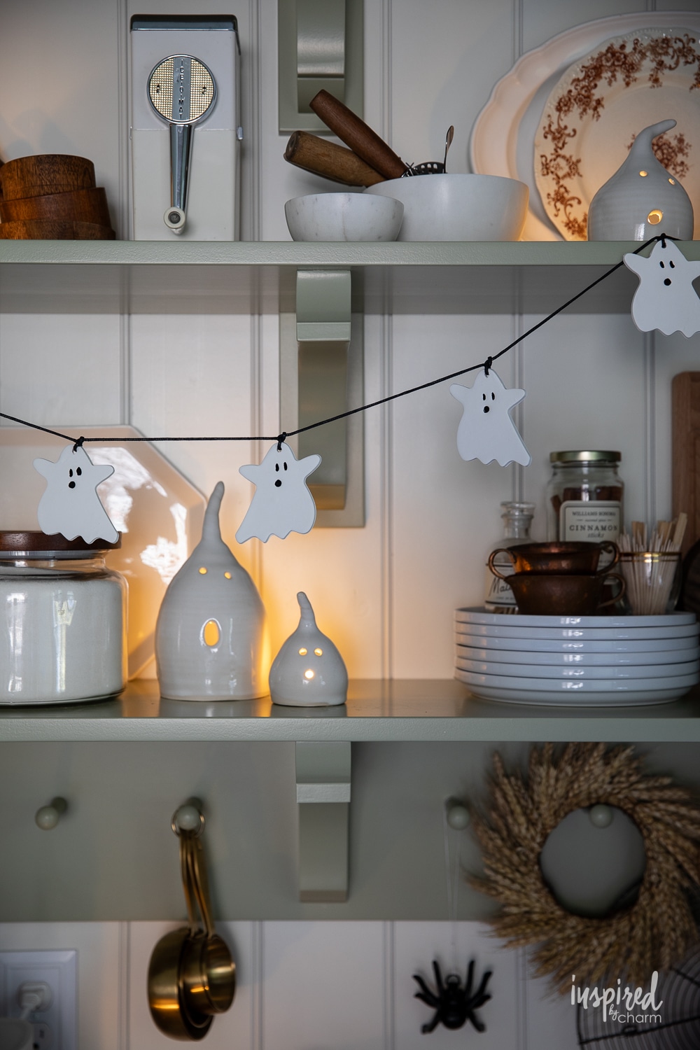 white ghost garland hung on kitchen shelves.