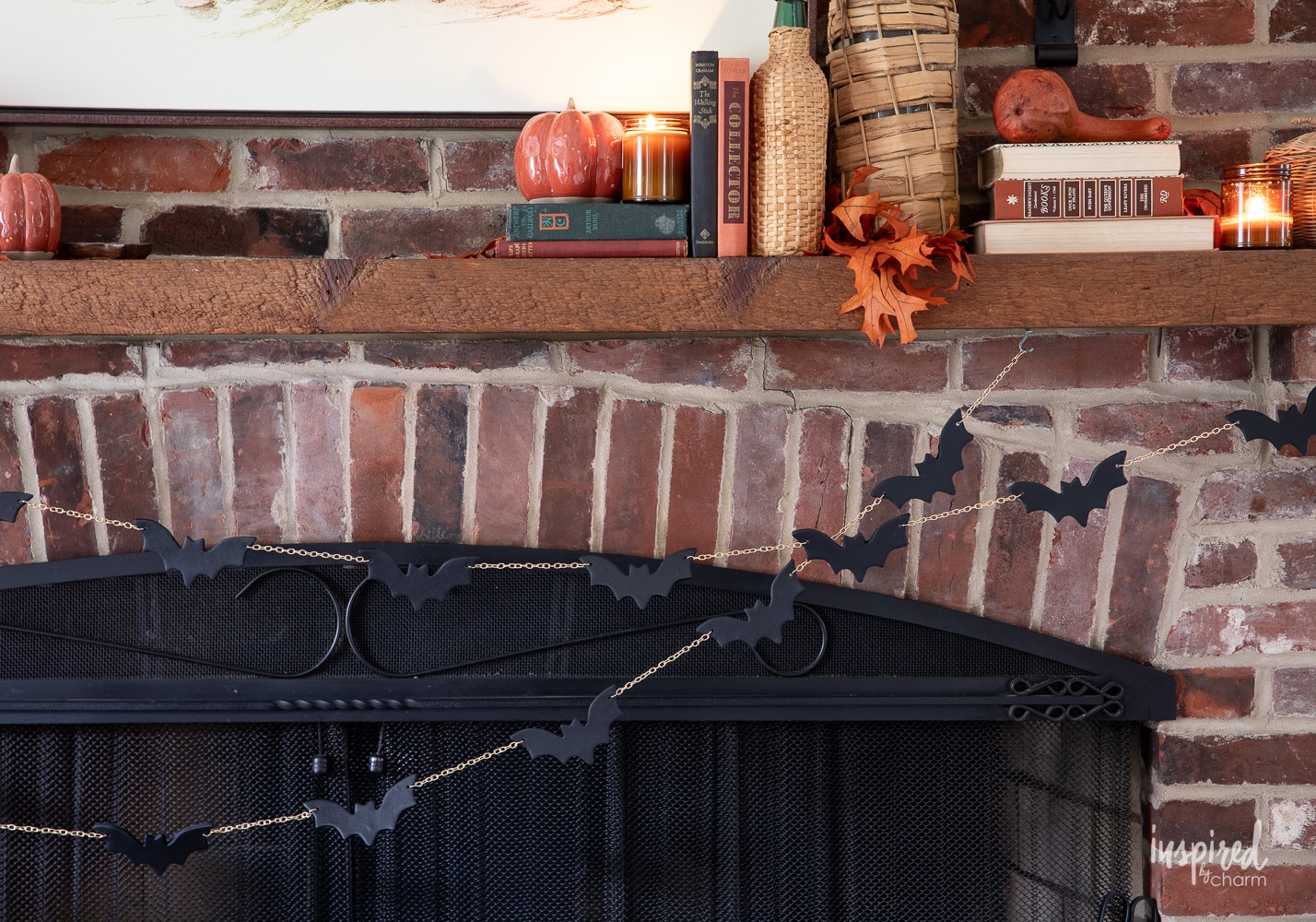 halloween diy bat garland hung on a brick mantel. 