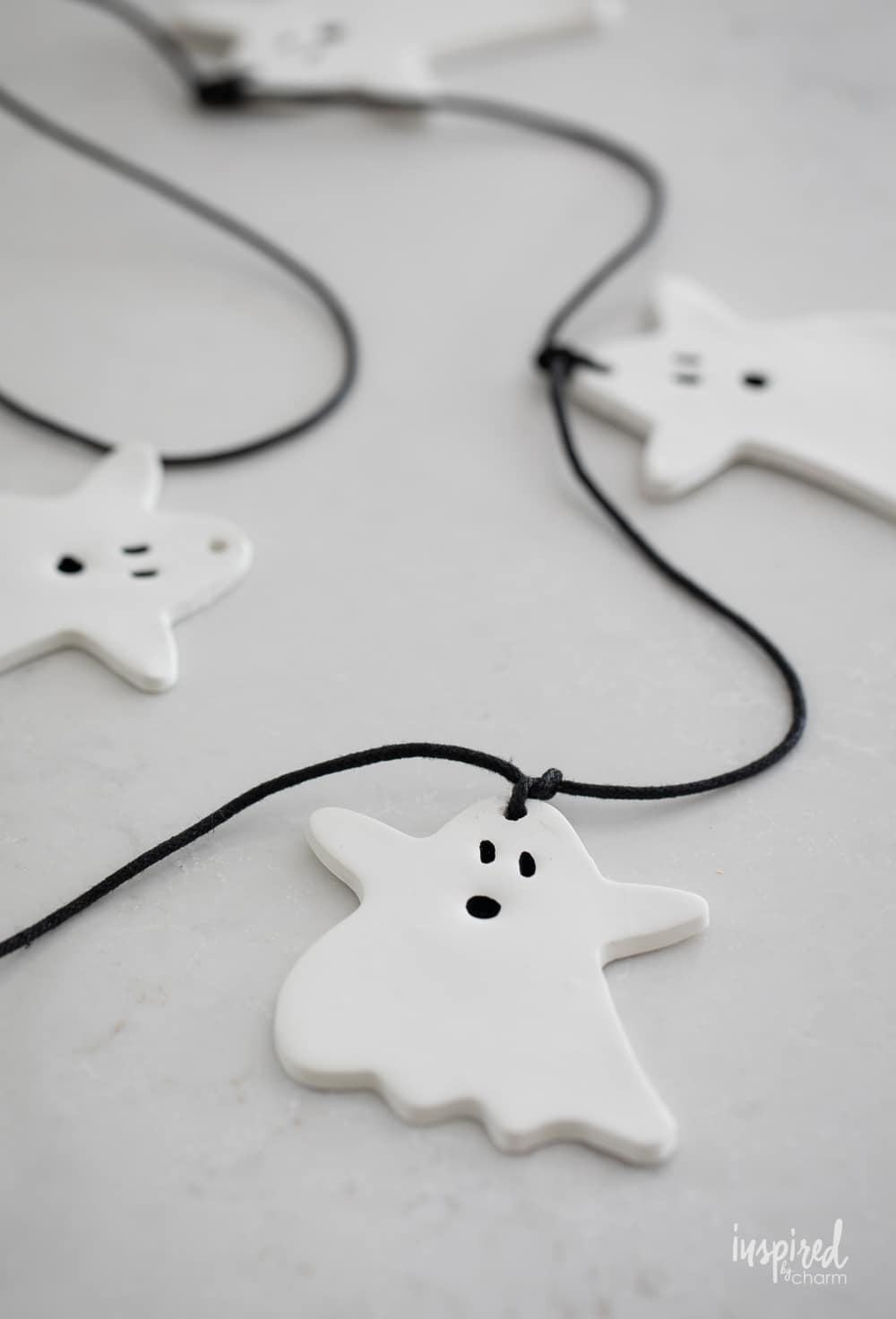 white clay ghost garland on a white countertop. 