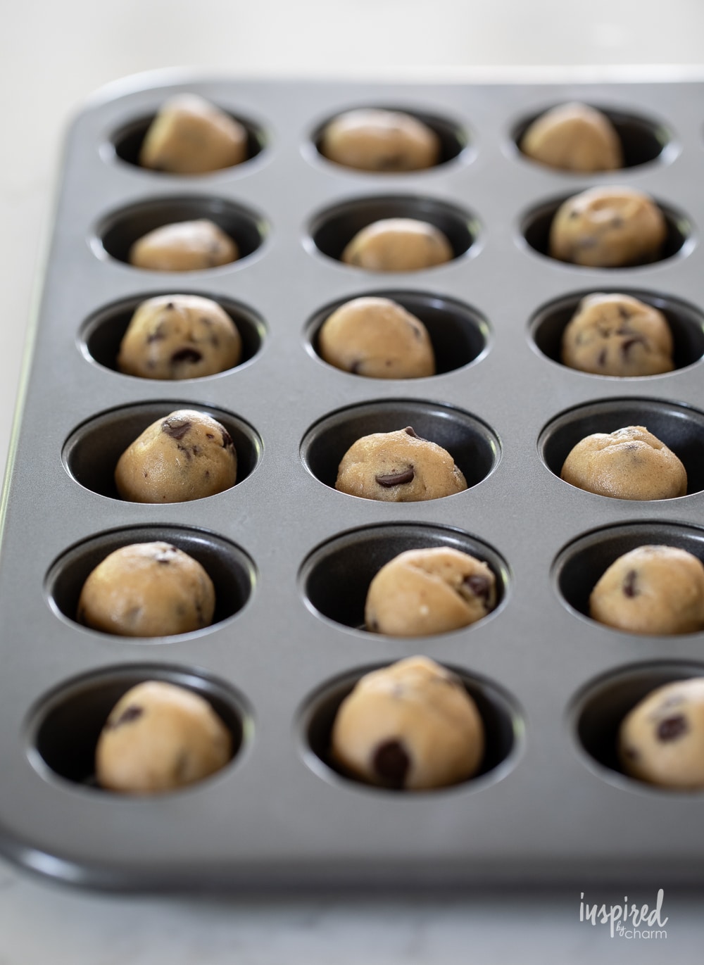 balls of cookie dough in mini muffin pans.