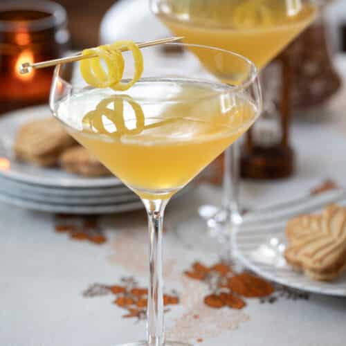 two maple martinis in glasses on a table.