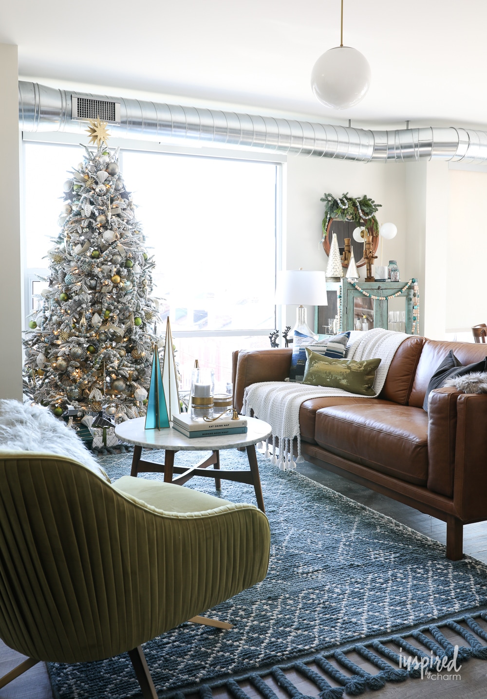 flocked christmas tree in modern apartment living room. 