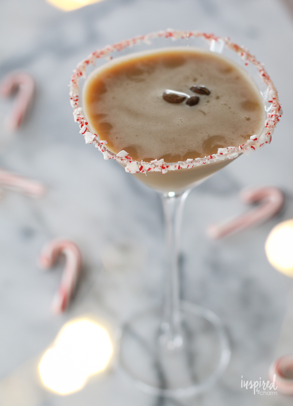 peppermint espresso martini in a glass with candy canes.