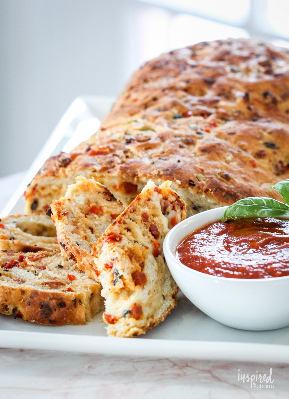 homemade pizza bread sliced and served with marinara sauce.