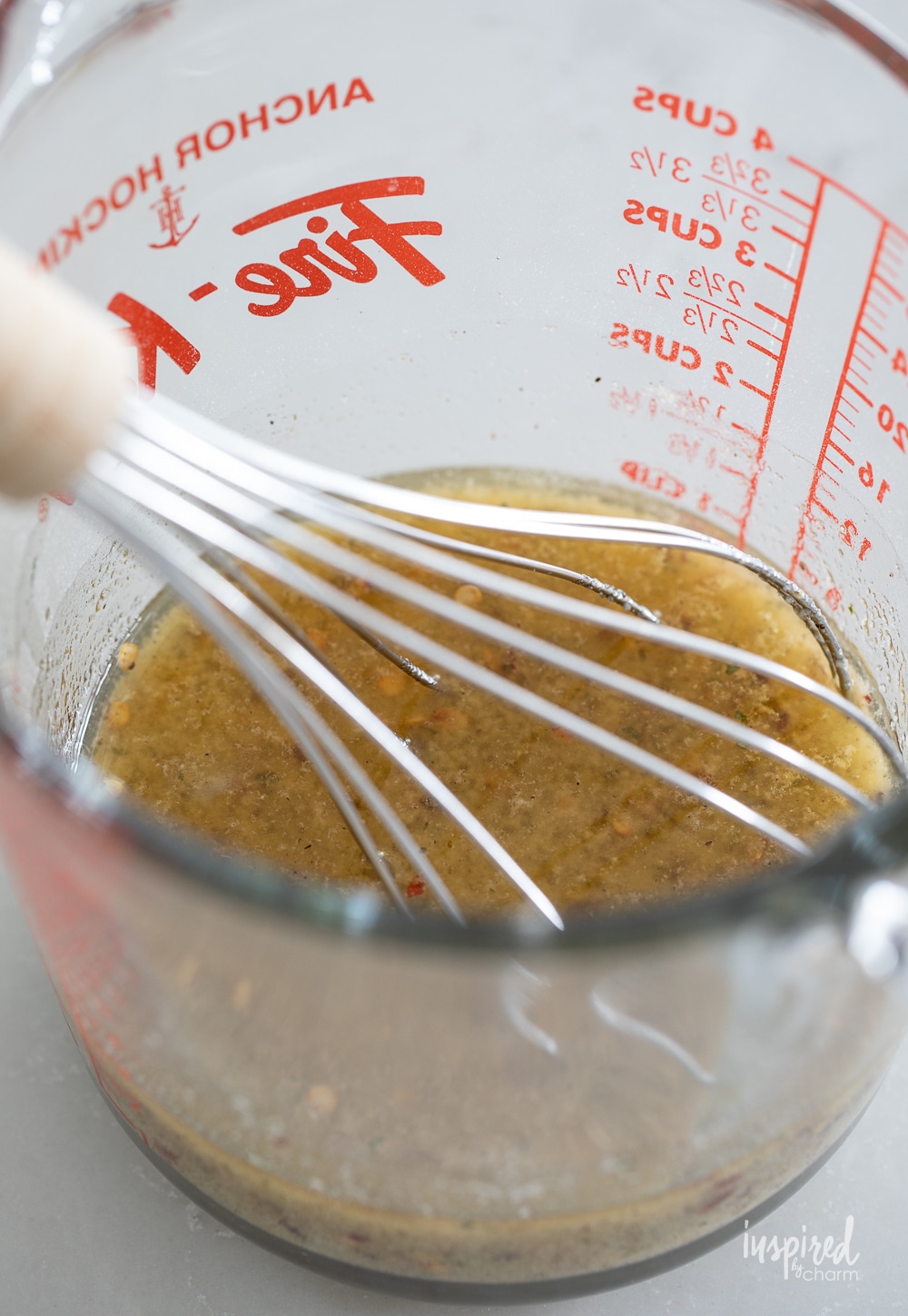seasoning mix for ranch fire crackers in a measuring cup.