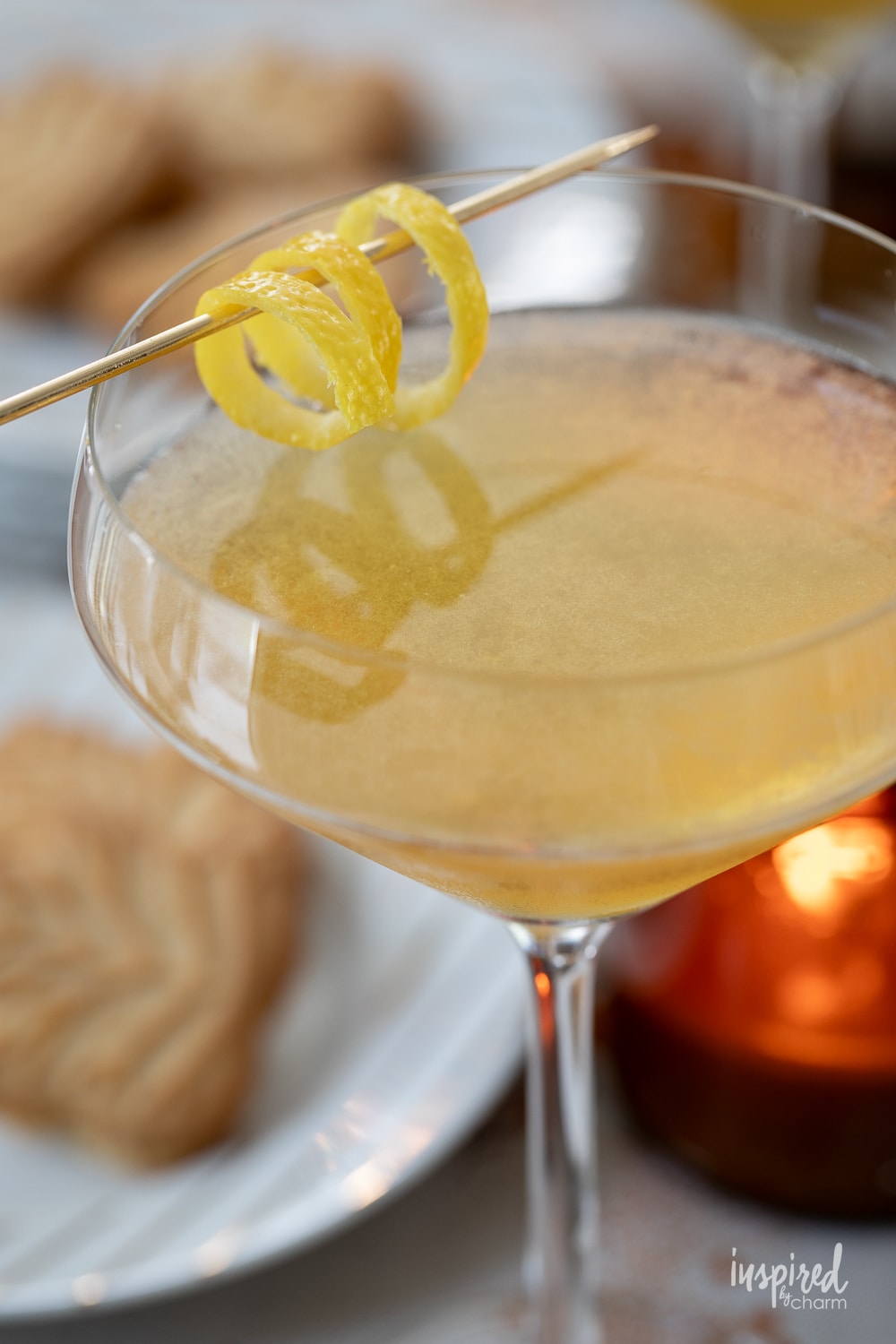 martini glass filled with maple martini and garnished with a lemon twist. 