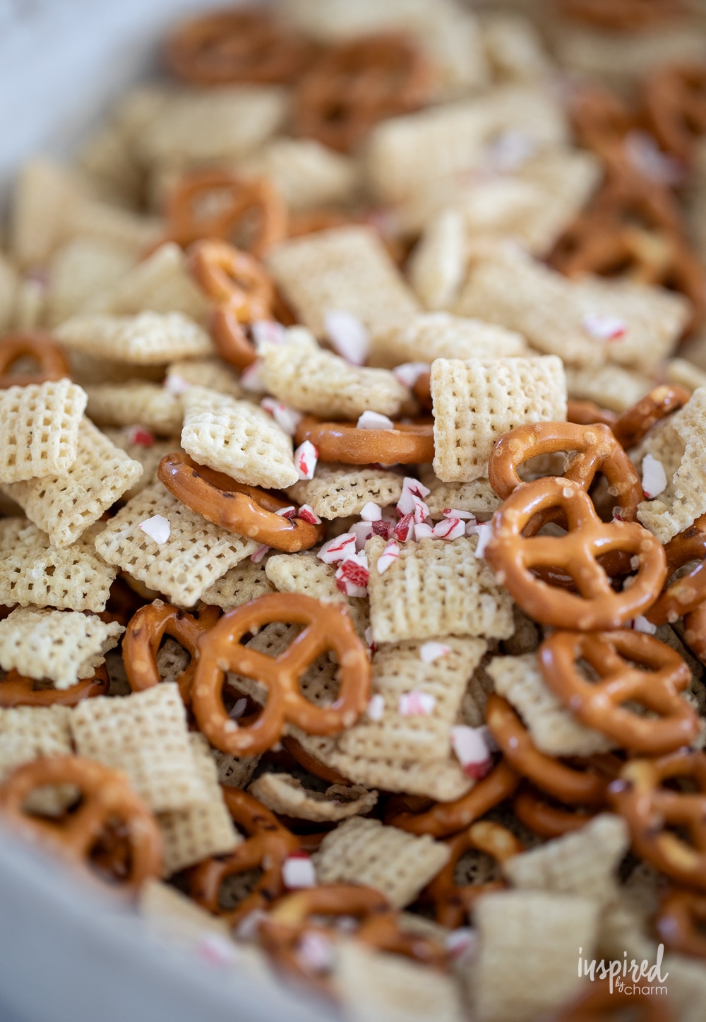 ingredients for peppermint white chocolate chex mix in a large bowl.