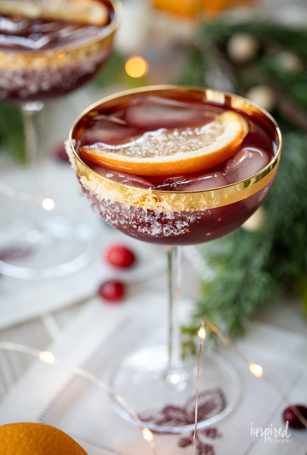mulled wine margarita in a gold rimmed coupe glass. 