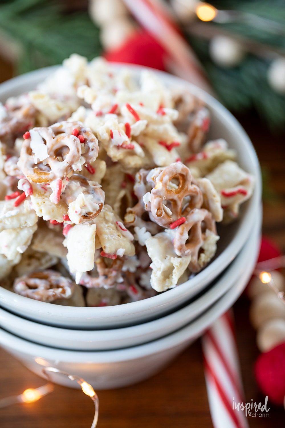 peppermint white chocolate chex mix in a small white bowl.