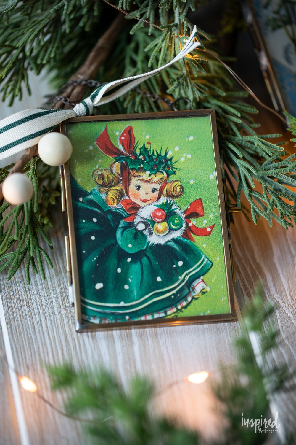 vintage inspired Christmas ornament surrounded by pine.
