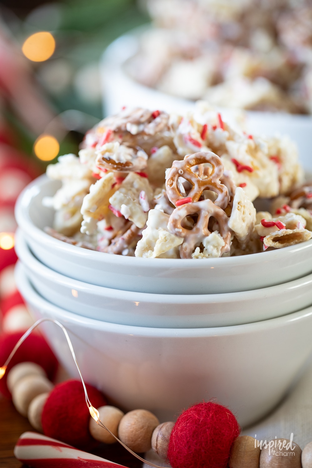 peppermint white chocolate chex mix served in small white bowls.