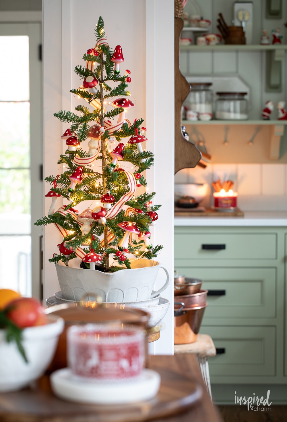 mini christmas tree decorate with ribbon and mushroom ornaments.