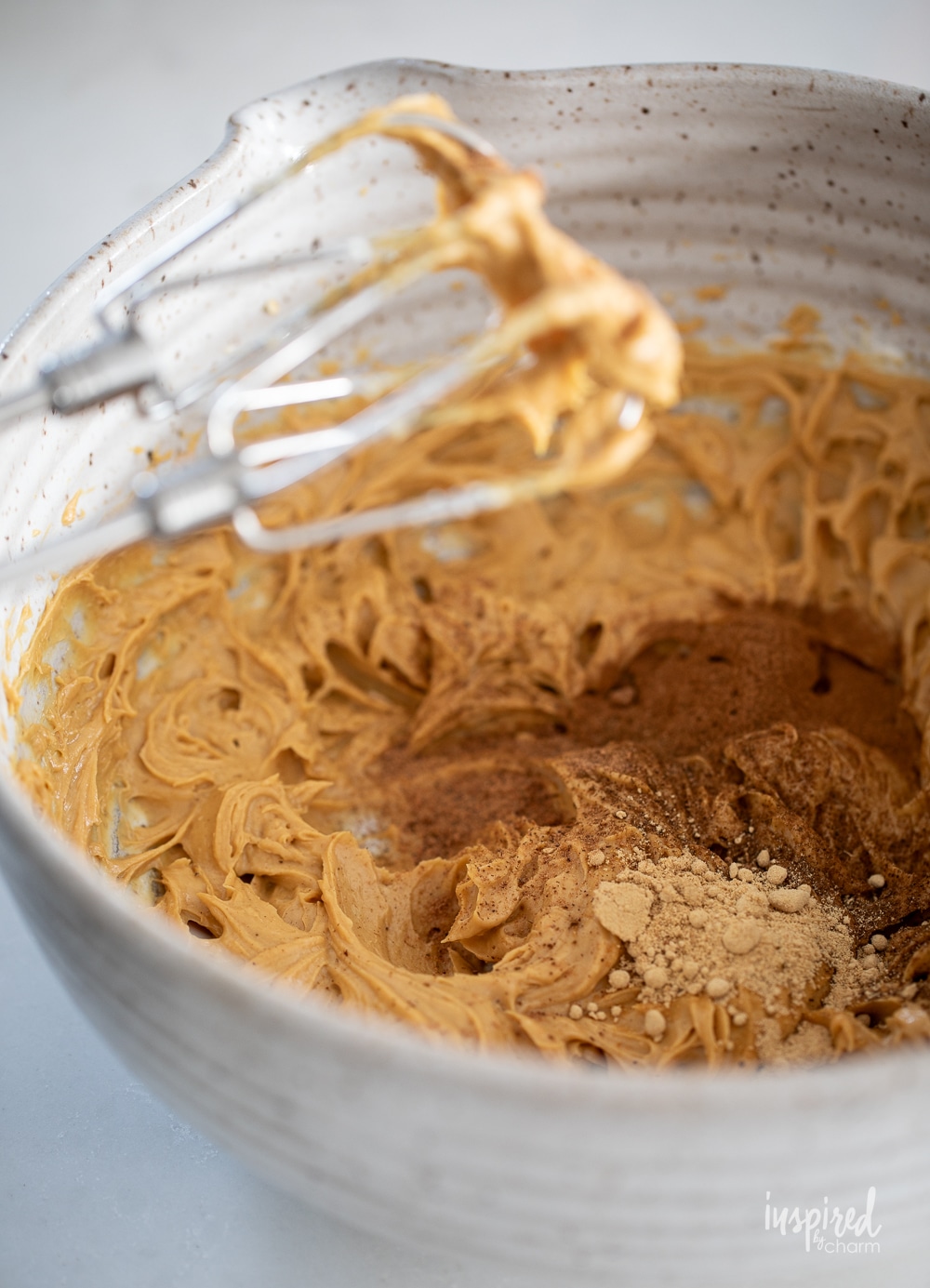 gingerbread dip mix in a mixing bowl with a mixer. 
