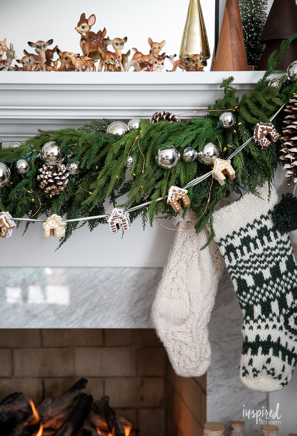 fireplace mantel with garland decor and stockings.