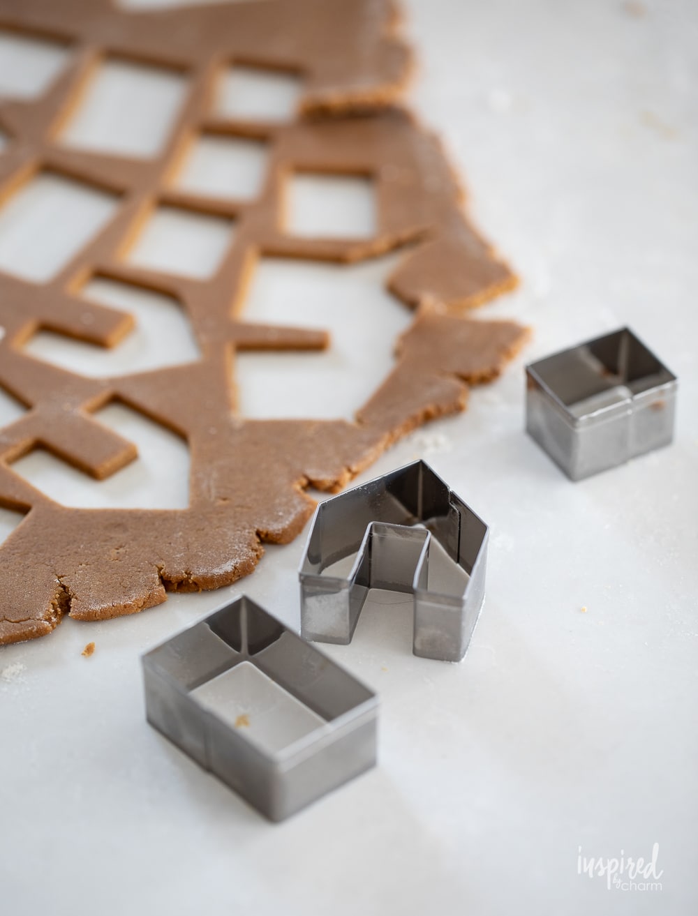 gingerbread cookie dough with cookie cutters.