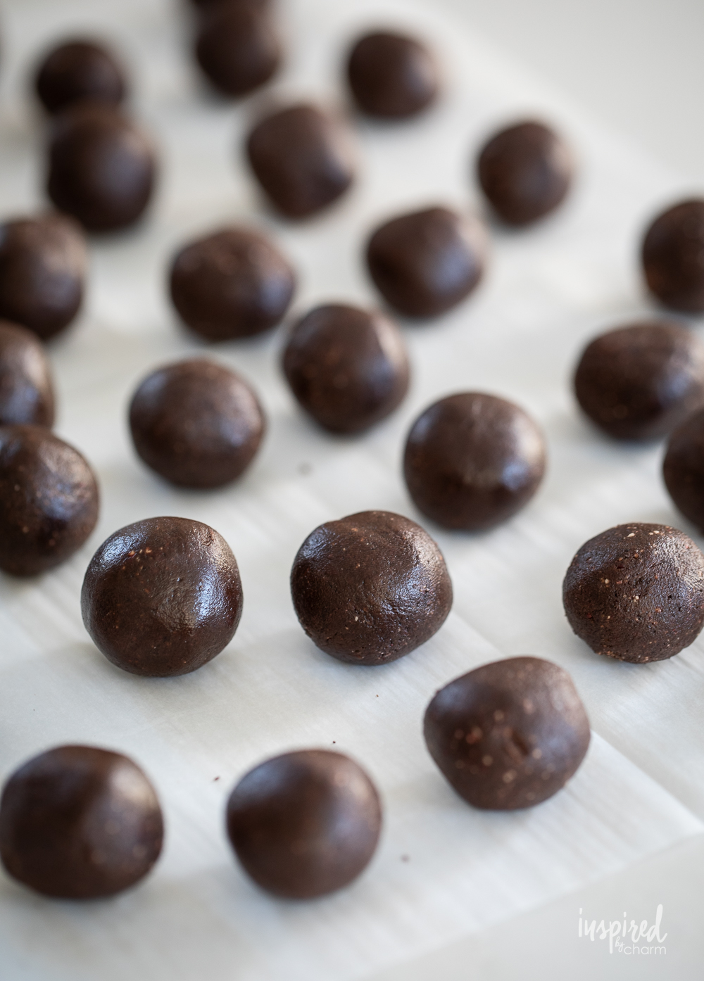 chocolate truffle balls on waxed paper.