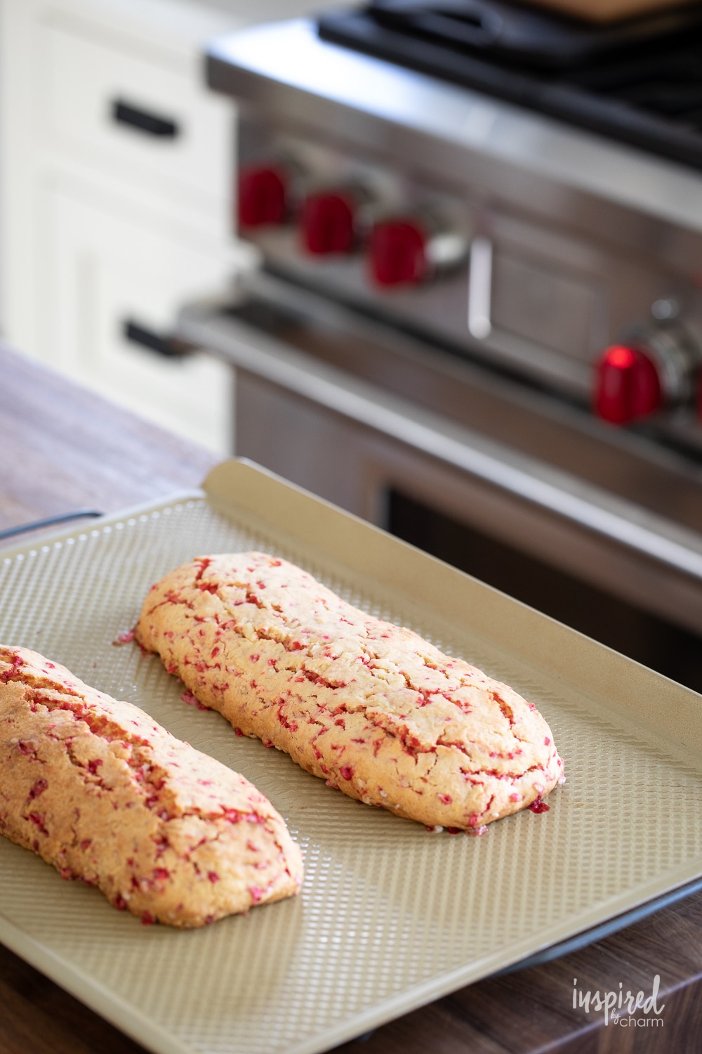 two loaves of peppermint biscotti on a baking sheet pan.