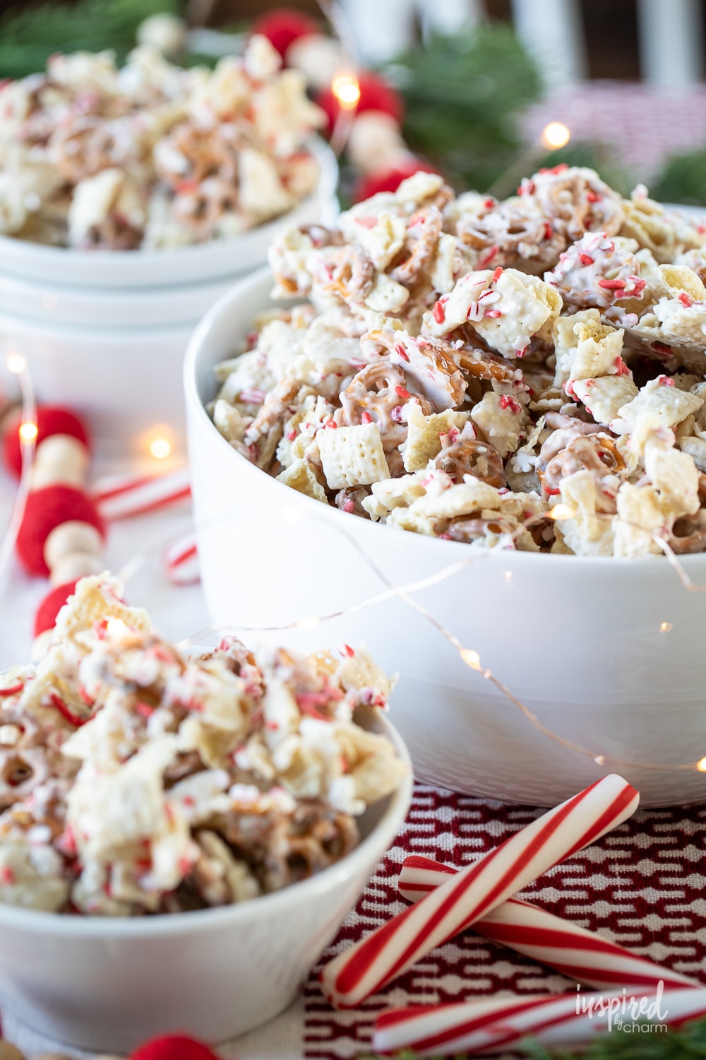 peppermint white chocolate chex mix in a large serving bowl and smaller bowls.