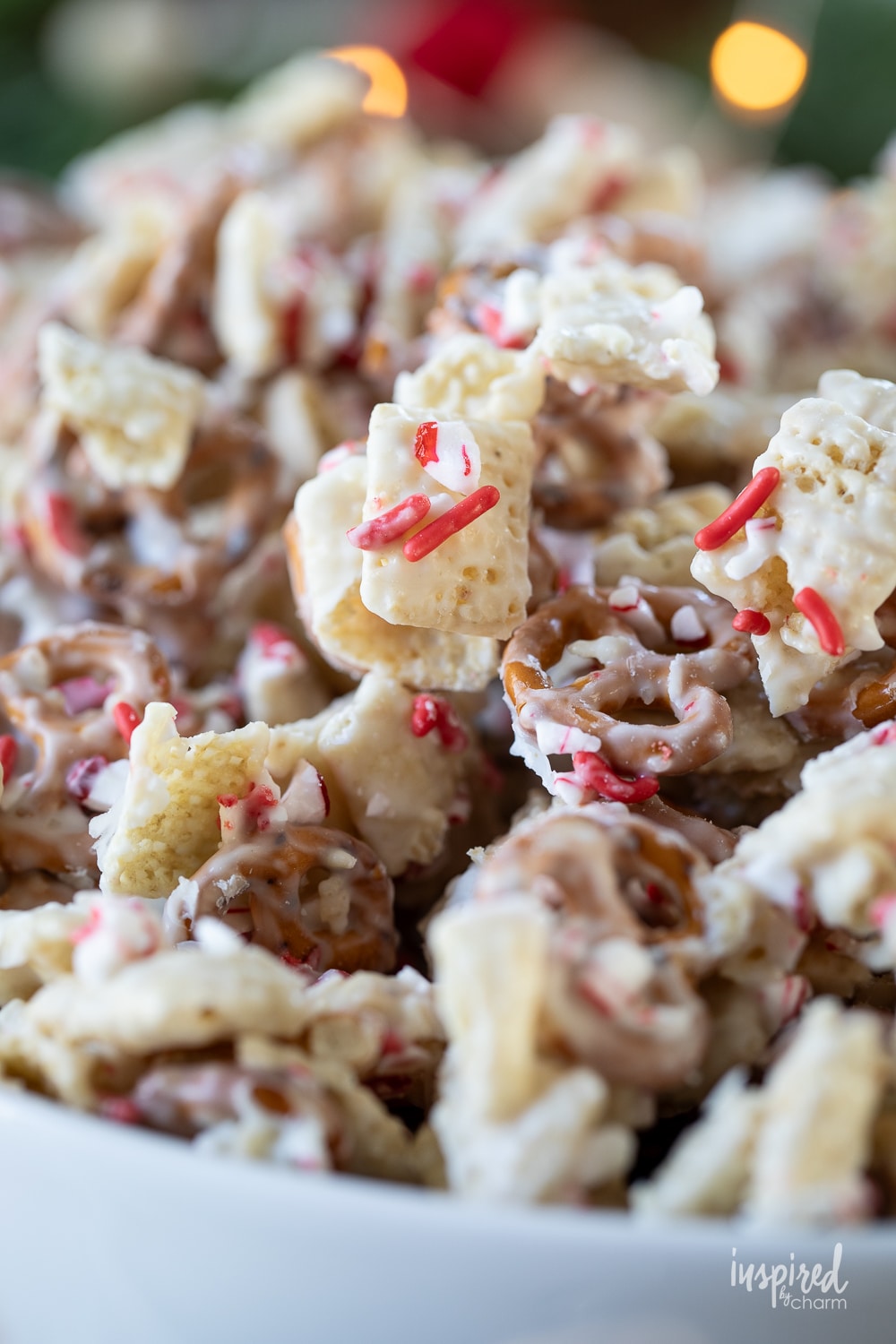 peppermint white chocolate chex mix in a small white bowl.