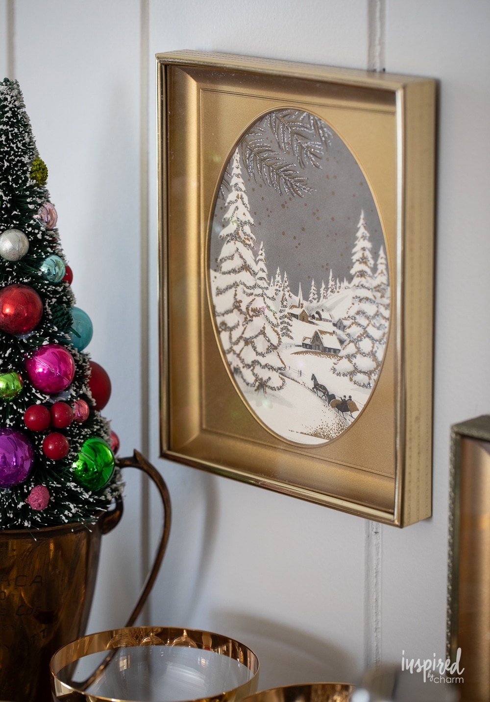 snowy scene christmas card framed in gold frame.