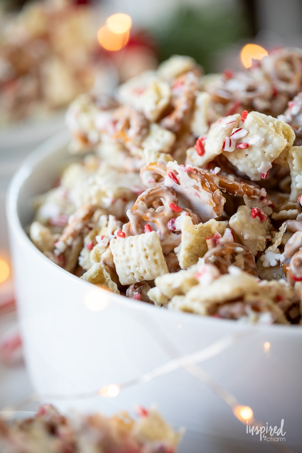 peppermint white chocolate chex mix in a large white serving bowl.