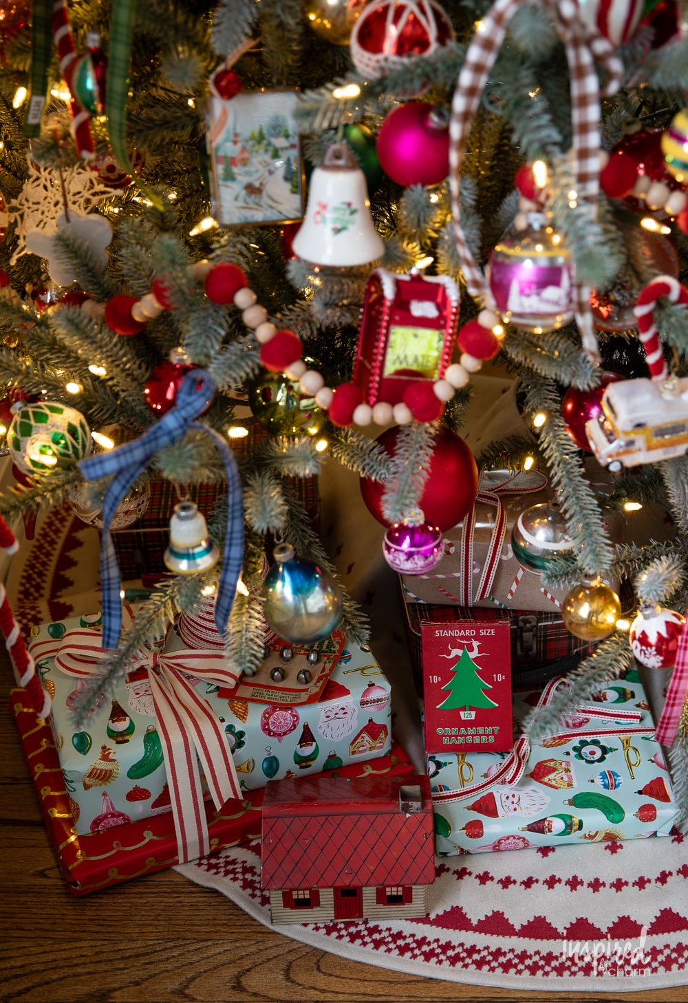 gifts and packages under a colorfully decorated christmas tree. 