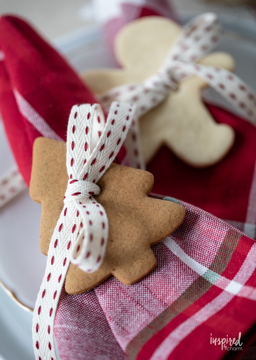two cookies with ribbon used as holiday napkin rings.