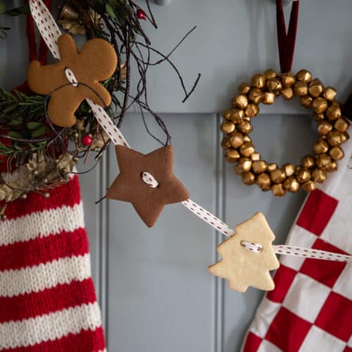 gingerbread cookie garland hung on pegs with festive decor.