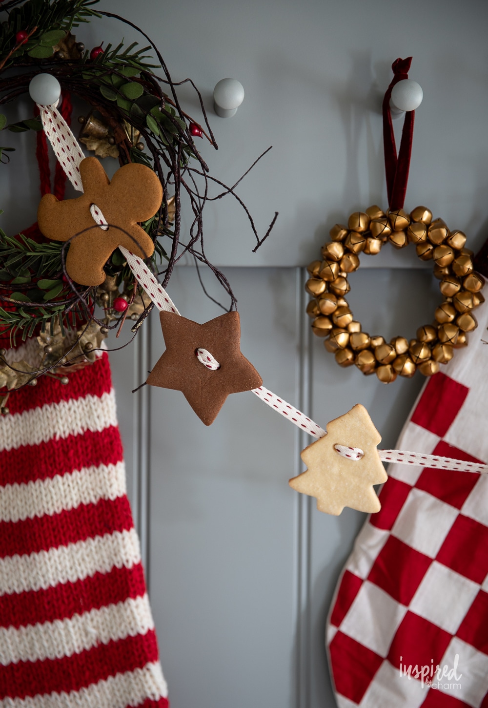 gingerbread cookie garland hung on pegs with festive decor.