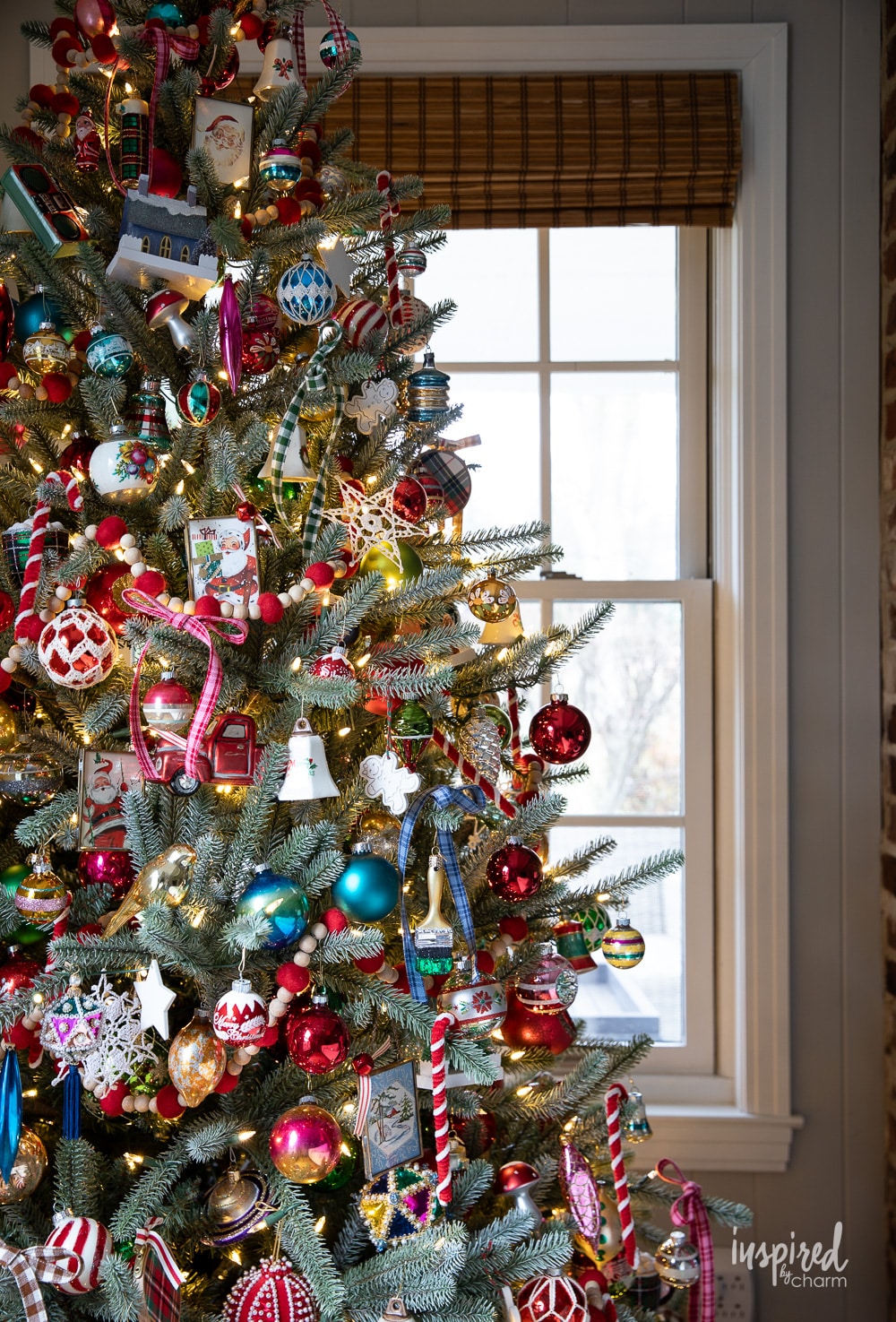 christmas tree filled with colorful vintage ornaments. 