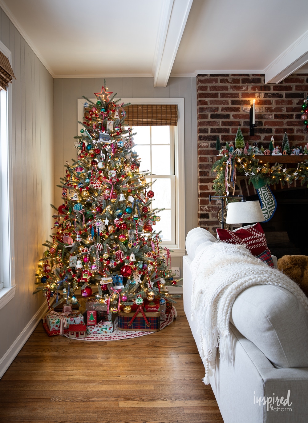 christmas tree in a living room decorated with colorful ornaments. 