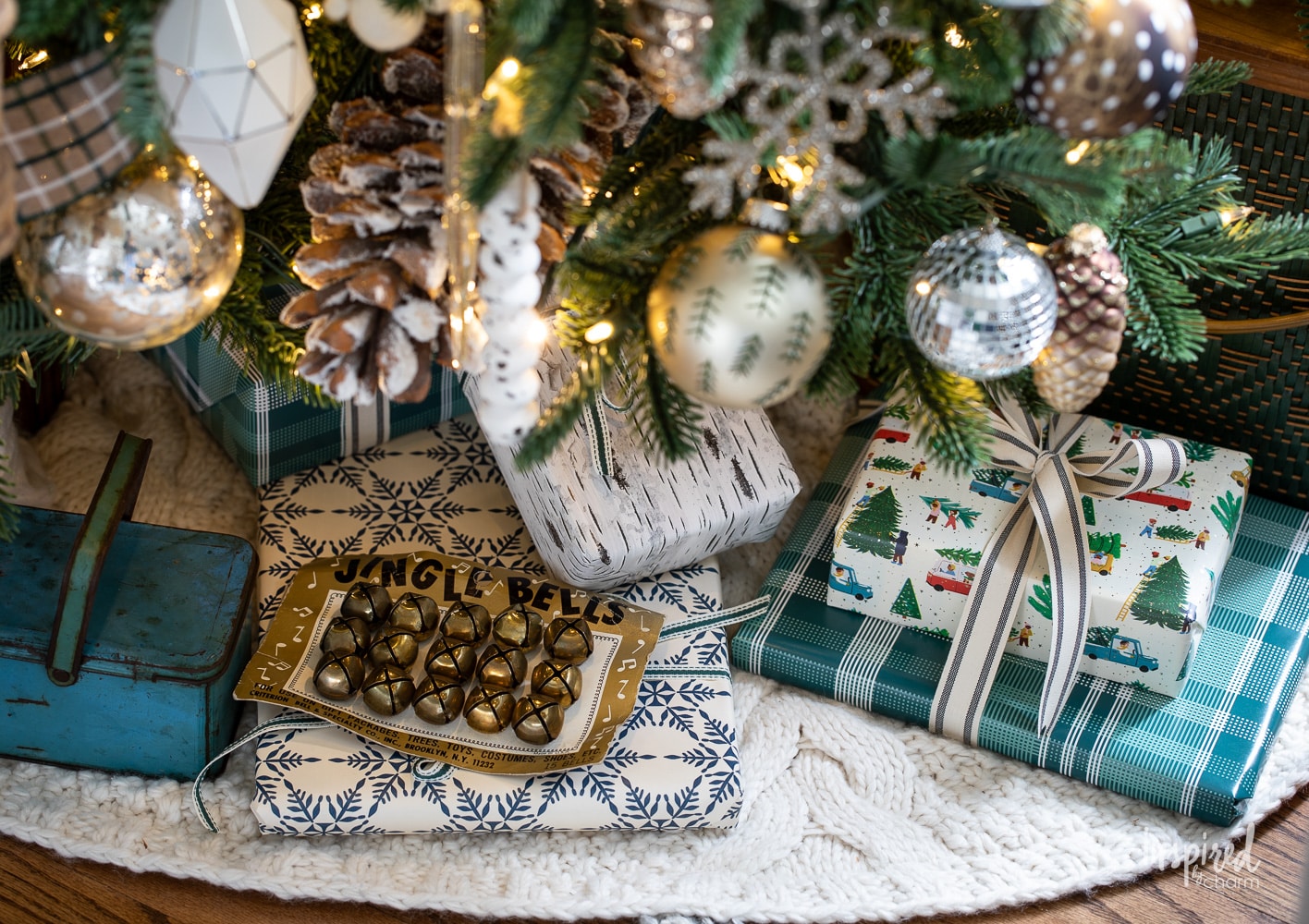 gifts and decor under a christmas tree.