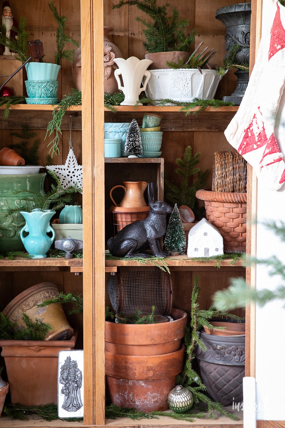 pine shed filled with pots, pine, and garden decor.