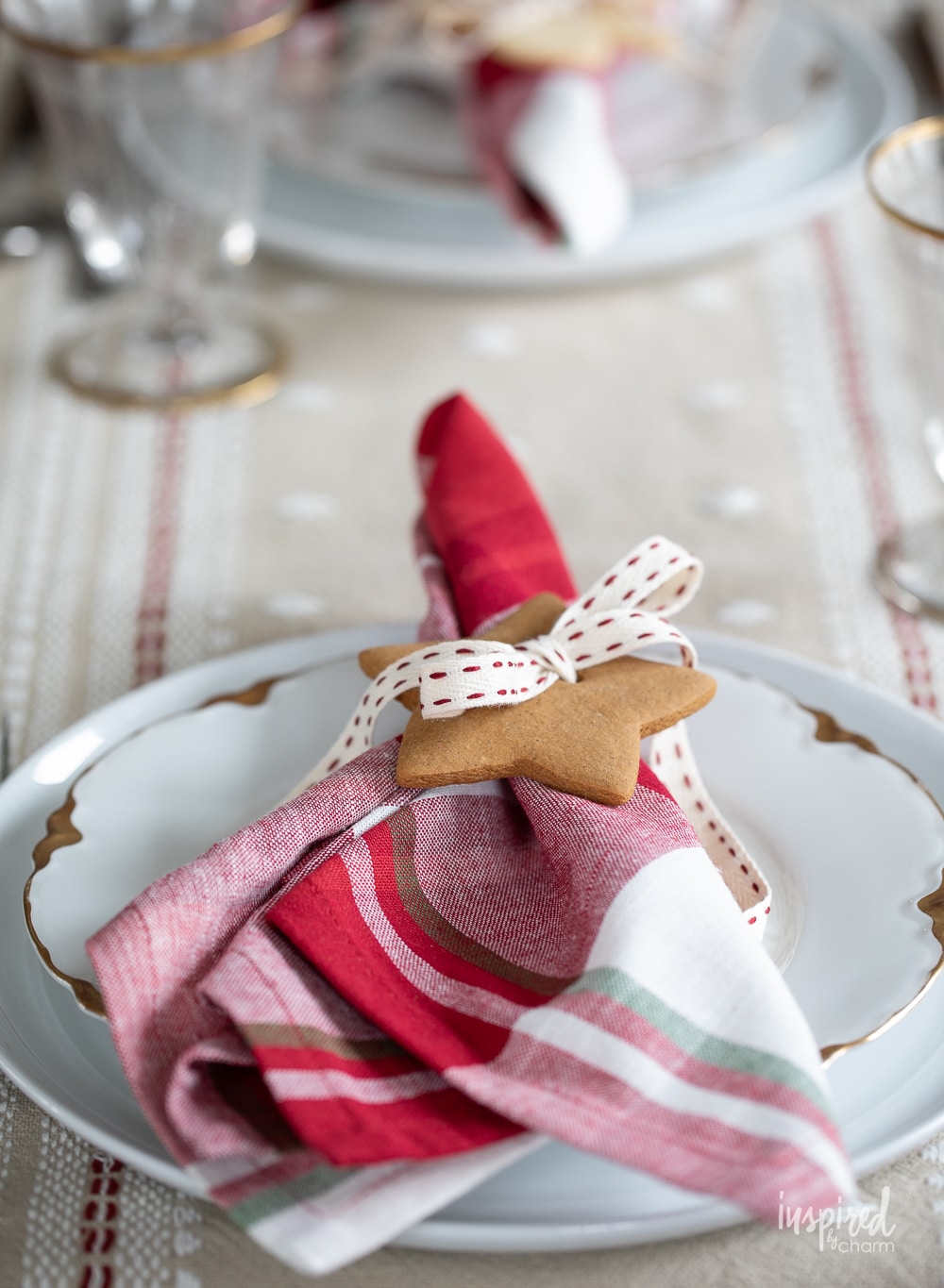 place setting with napkin and cookie and ribbon as a napkin ring.