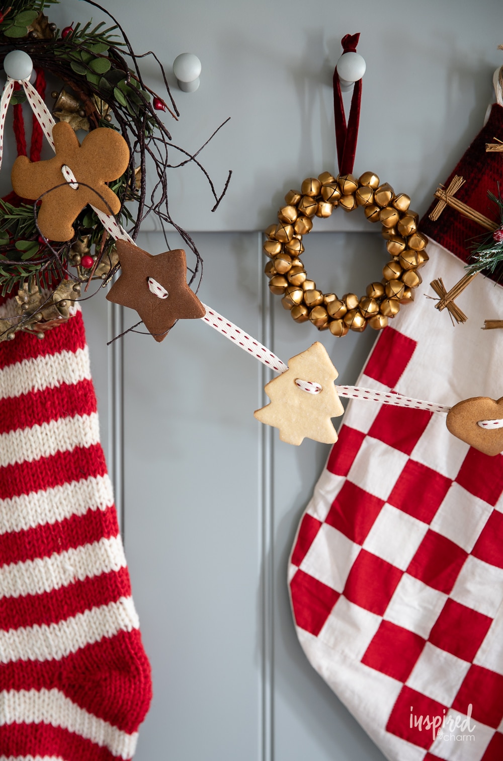 gingerbread cookie garland hung on peg rap with festive christmas decor.