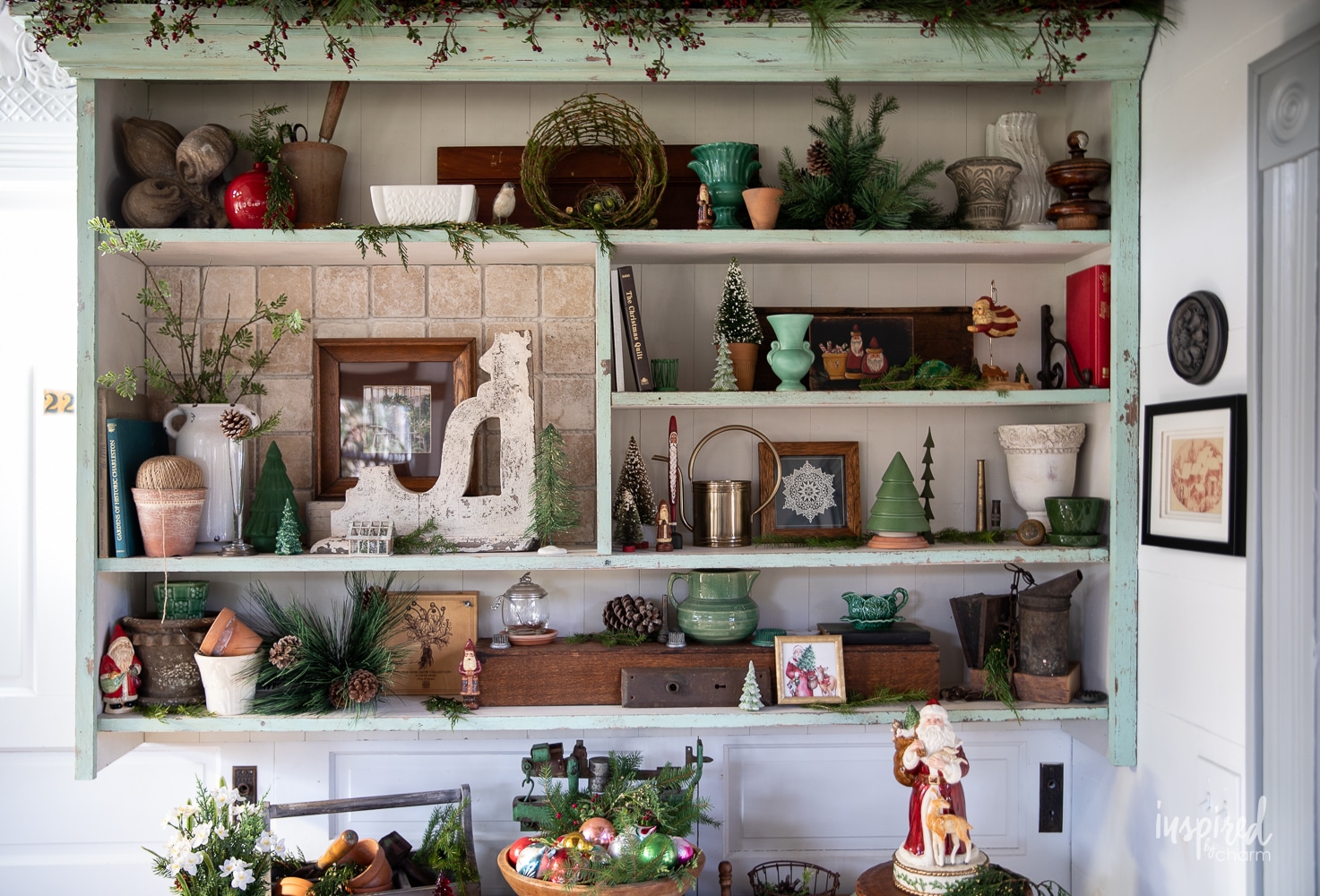 shelf filled with christmas and vintage decor.