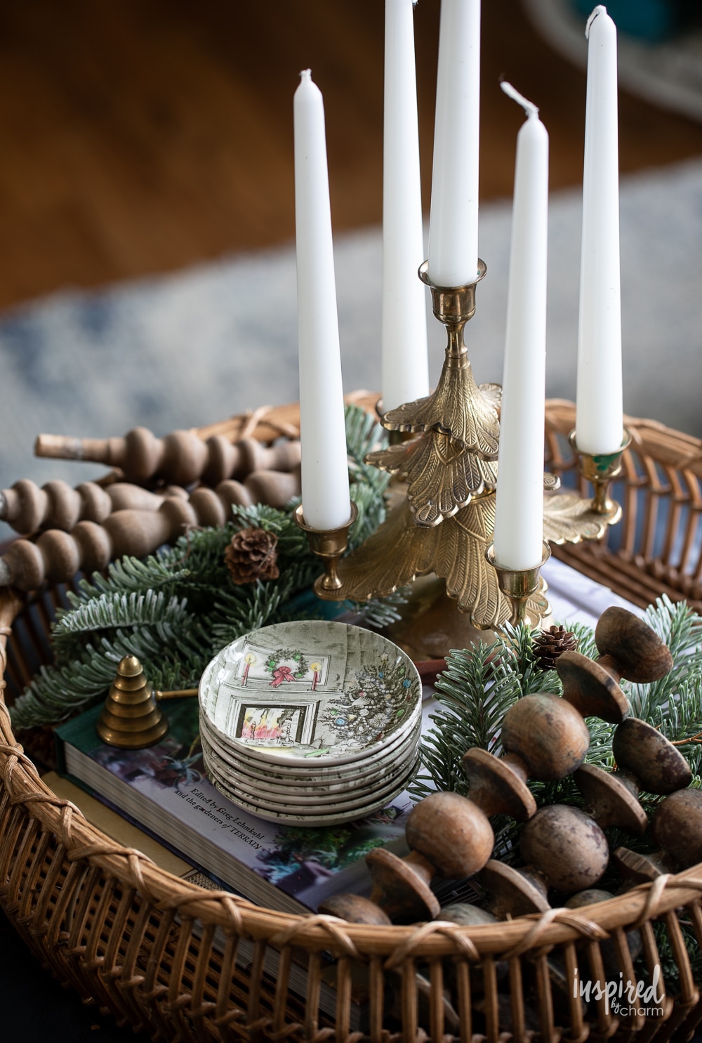 coffee table ottoman with brass tree candle holder and christmas coasters.