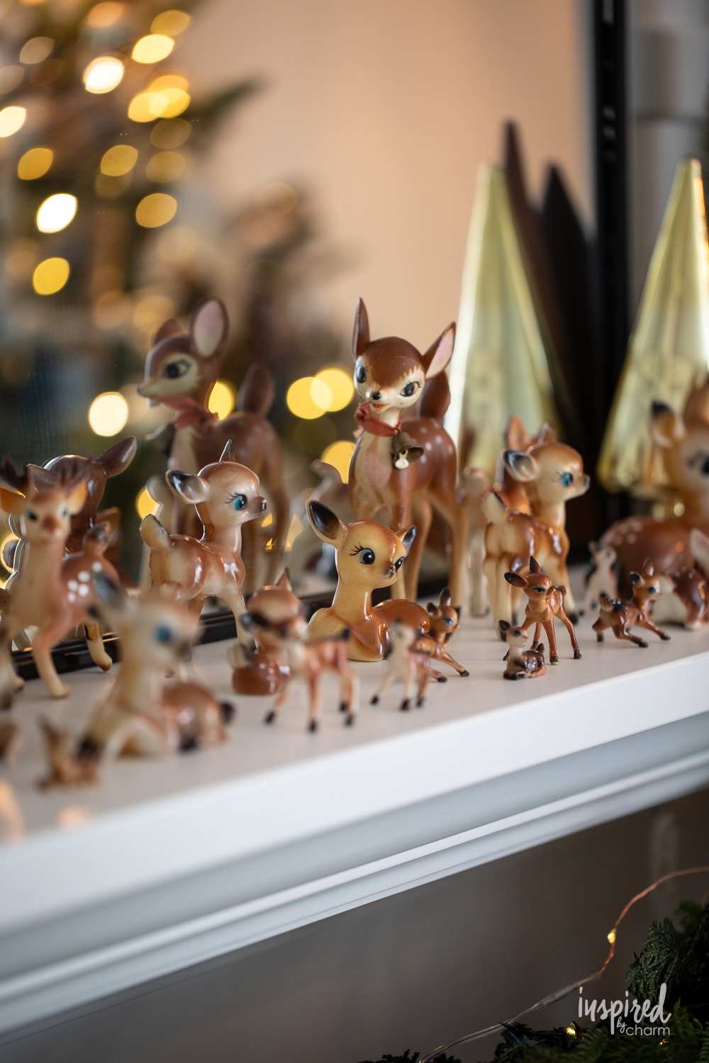 vintage deer collection on a mantel fro Christmas.